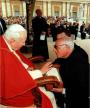 Fr. Maximilian Mizzi receiving a blessing from Pope on the “ Sacred Stone ” .